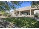Inviting backyard featuring a manicured lawn and covered patio, perfect for outdoor relaxation and entertainment at 35108 N 139Th Way, Scottsdale, AZ 85262