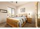Bedroom featuring a wooden bed frame, plush carpet, a window with blinds, and natural light at 35108 N 139Th Way, Scottsdale, AZ 85262
