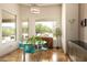 Breakfast nook featuring a round glass table, blue chairs, and outdoor views at 35108 N 139Th Way, Scottsdale, AZ 85262