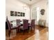 Modern dining room with glass table, six purple chairs and contemporary decor at 35108 N 139Th Way, Scottsdale, AZ 85262