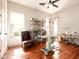 A well-lit flex room with wood floors, a ceiling fan, and ample storage space at 35108 N 139Th Way, Scottsdale, AZ 85262