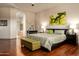 Main bedroom with wood floors, neutral walls, an archway to the ensuite, and a plush king bed at 35108 N 139Th Way, Scottsdale, AZ 85262