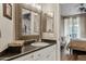 Elegant bathroom featuring granite counters, modern fixtures, decorative mirror, and access to the main bedroom at 3633 N 3Rd Ave # 1035, Phoenix, AZ 85013