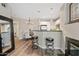Modern kitchen with stainless steel appliances, breakfast bar, and open layout to dining area at 3633 N 3Rd Ave # 1035, Phoenix, AZ 85013