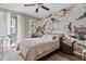 Calm main bedroom with large floral wallpaper, modern decor, and sliding glass door to balcony at 3633 N 3Rd Ave # 1035, Phoenix, AZ 85013