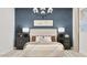 Bedroom with a cozy bed, accent wall, neutral bedding, and decorative lamps offers comfort and style at 3758 E Gold Mountain Ave, San Tan Valley, AZ 85143