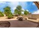 Well maintained backyard featuring a concrete patio with a built-in grill at 4038 E Wrangler Ct, Gilbert, AZ 85297