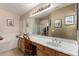 Bathroom with a large mirror, a vanity, and a combined tub and shower at 4038 E Wrangler Ct, Gilbert, AZ 85297