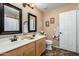 Bathroom with double sinks, decorative mirrors, and modern lighting fixtures at 4038 E Wrangler Ct, Gilbert, AZ 85297