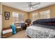 Neutral bedroom with natural light, ceiling fan, and casual furnishings at 4038 E Wrangler Ct, Gilbert, AZ 85297