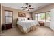 Bright bedroom features a neutral color scheme, ceiling fan, and plush carpet floors at 4038 E Wrangler Ct, Gilbert, AZ 85297
