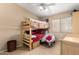Comfortable bedroom with a wooden bunk bed and a cozy chair at 4038 E Wrangler Ct, Gilbert, AZ 85297