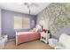 Charming bedroom with a tree wall decal, soft carpet and a comfortable bed at 4038 E Wrangler Ct, Gilbert, AZ 85297