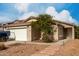 Charming single-story home featuring a well-maintained yard with desert landscaping and a two car garage at 4038 E Wrangler Ct, Gilbert, AZ 85297
