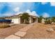 Single-story home with desert landscaping, two car garage, and walkway leading to the front door at 4038 E Wrangler Ct, Gilbert, AZ 85297