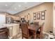 Well-lit kitchen and dining area with stainless steel appliances and a wooden dining table at 4038 E Wrangler Ct, Gilbert, AZ 85297