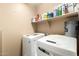 Functional laundry room featuring a modern washer and dryer set at 4038 E Wrangler Ct, Gilbert, AZ 85297