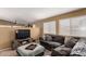 Open-concept living room features modern tile flooring, comfortable seating, and an entertainment center at 4038 E Wrangler Ct, Gilbert, AZ 85297