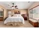 Comfortable bedroom with natural light, carpet, and a ceiling fan at 4038 E Wrangler Ct, Gilbert, AZ 85297