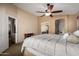 Spacious main bedroom with a ceiling fan and access to the bathroom and closet at 4038 E Wrangler Ct, Gilbert, AZ 85297