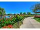 Beautiful community pond with colorful flower beds, trees, and walking path at 4038 E Wrangler Ct, Gilbert, AZ 85297