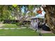 Picturesque backyard featuring a large tree, covered patio, and unique decorations at 4139 E Edgemont Ave, Phoenix, AZ 85008
