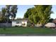 Charming single-story home with mature trees and a well-manicured lawn at 4139 E Edgemont Ave, Phoenix, AZ 85008