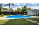 Backyard featuring a refreshing in-ground pool, shed, and landscaping at 4139 E Edgemont Ave, Phoenix, AZ 85008