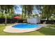 Inviting backyard pool area with a shed, and red umbrella at 4139 E Edgemont Ave, Phoenix, AZ 85008
