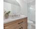 Updated bathroom with wood vanity, stone countertop, gold mirror, and a glass enclosed shower at 4201 E Camelback Rd # 70, Phoenix, AZ 85018