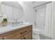 Bathroom featuring a vanity with stone countertop, an oval mirror and a shower-tub combination at 4201 E Camelback Rd # 70, Phoenix, AZ 85018
