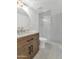 Contemporary bathroom boasts a glass shower, wood vanity, and round mirror at 4201 E Camelback Rd # 70, Phoenix, AZ 85018