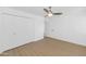 Bedroom with hardwood flooring, a large closet with doors, and a ceiling fan with light fixture at 4201 E Camelback Rd # 70, Phoenix, AZ 85018