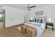 Bright bedroom featuring modern ceiling fan, woven bench, and stylish decor at 4201 E Camelback Rd # 70, Phoenix, AZ 85018
