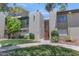 Exterior view of a two-story apartment building surrounded by lush landscaping and green grass at 4201 E Camelback Rd # 70, Phoenix, AZ 85018