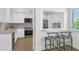 Modern kitchen with stainless steel appliances and white cabinets with bar stool seating at 4201 E Camelback Rd # 70, Phoenix, AZ 85018