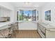 Sunlit breakfast nook features a view of the community pool through shuttered windows at 4201 E Camelback Rd # 70, Phoenix, AZ 85018