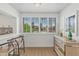 A well-lit kitchen nook with bar seating offers serene views of a lush, tropical landscape through shuttered windows at 4201 E Camelback Rd # 70, Phoenix, AZ 85018