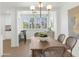Cozy dining area next to the kitchen features a wooden table, stylish wicker chairs, and bright natural light at 4201 E Camelback Rd # 70, Phoenix, AZ 85018