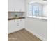 Modern kitchen with white cabinets and elegant stone backsplash and breakfast nook at 4201 E Camelback Rd # 70, Phoenix, AZ 85018