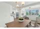 Bright open kitchen featuring stainless steel appliances, white cabinets, and wood flooring extending to the dining area at 4201 E Camelback Rd # 70, Phoenix, AZ 85018