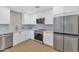 Modern kitchen with white cabinets, stainless steel appliances, and bright countertops at 4201 E Camelback Rd # 70, Phoenix, AZ 85018