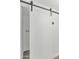 White sliding door to laundry room with modern hardware and fixtures at 4201 E Camelback Rd # 70, Phoenix, AZ 85018