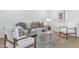 Bright living room featuring stylish seating arrangements, modern decor, and light-colored flooring and walls at 4201 E Camelback Rd # 70, Phoenix, AZ 85018