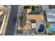 An aerial view of a property featuring a pool, covered patio, solar panels, and well-kept landscaping at 4202 W Purdue Ave, Phoenix, AZ 85051
