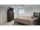 Bedroom with a bed, dresser, TV and marble floors at 4202 W Purdue Ave, Phoenix, AZ 85051