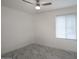 Bedroom features white walls, marble floors, modern ceiling fan and window with blinds at 4202 W Purdue Ave, Phoenix, AZ 85051