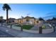 Attractive exterior of home with desert landscaping, manicured lawn, and solar panels at 4202 W Purdue Ave, Phoenix, AZ 85051
