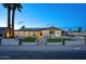 Inviting home exterior showcasing manicured landscaping, solar panels, and welcoming entrance lights at 4202 W Purdue Ave, Phoenix, AZ 85051