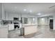 Bright kitchen features stainless appliances, a subway tile backsplash, and an island overlooking the living area at 4202 W Purdue Ave, Phoenix, AZ 85051